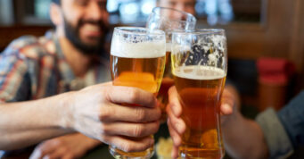 People toasting beer at brewery